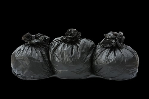 Workers sorting different types of builders waste